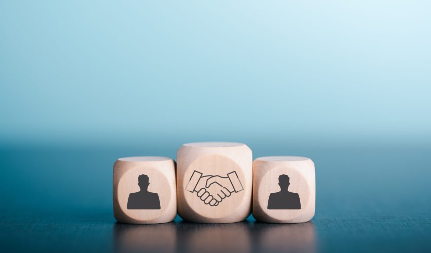 Wooden blocks laid on wooden floor, the concept of cooperation. teamwork Colleagues, friendship, unity, which is the strategy to develop the success of companies and organizations. to new innovation